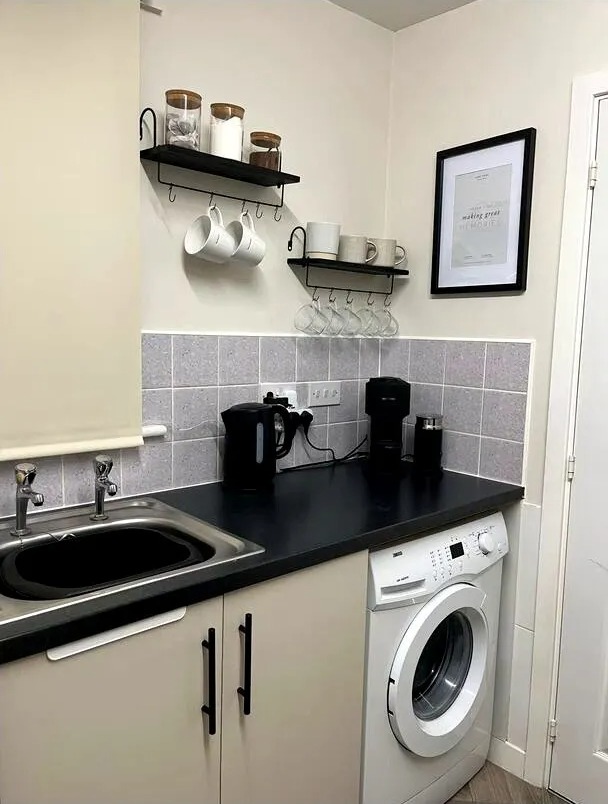 Kitchen makeover with new shelves, mugs, and appliances.