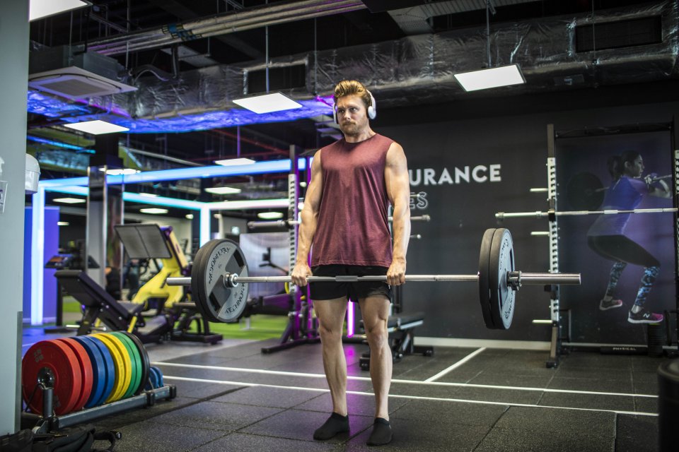 Man lifting weights in a gym.