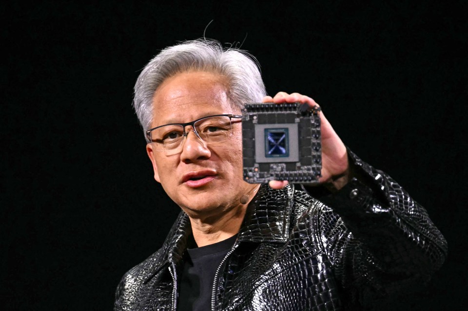 Jensen Huang, Nvidia CEO, holding a computer chip.