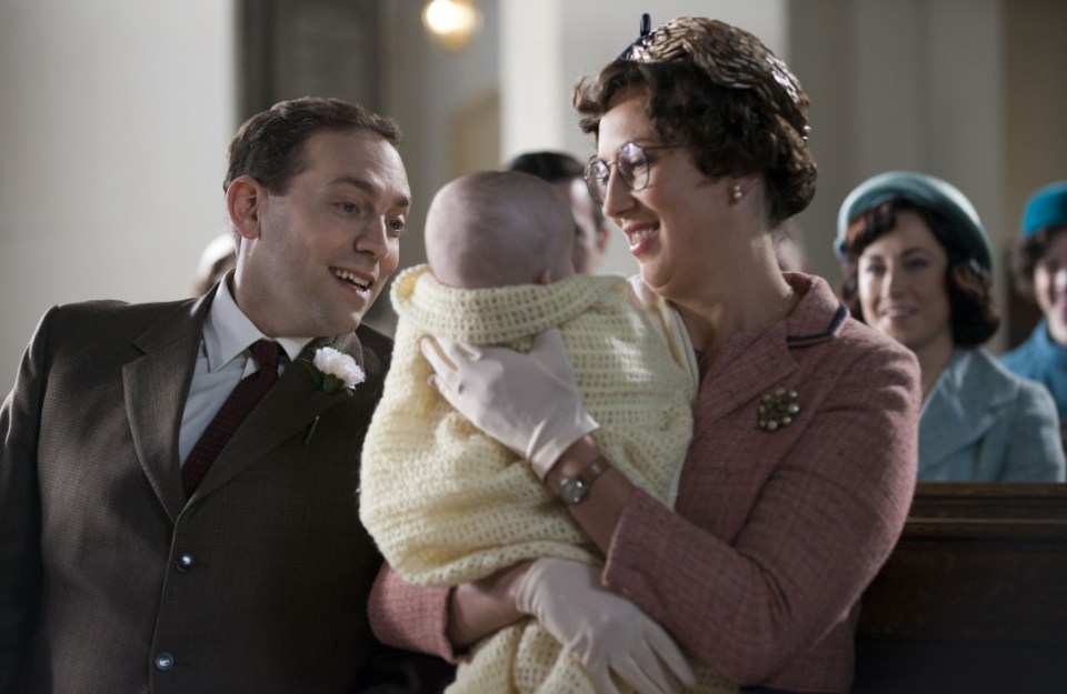 Scene from Call the Midwife showing a couple holding a baby.