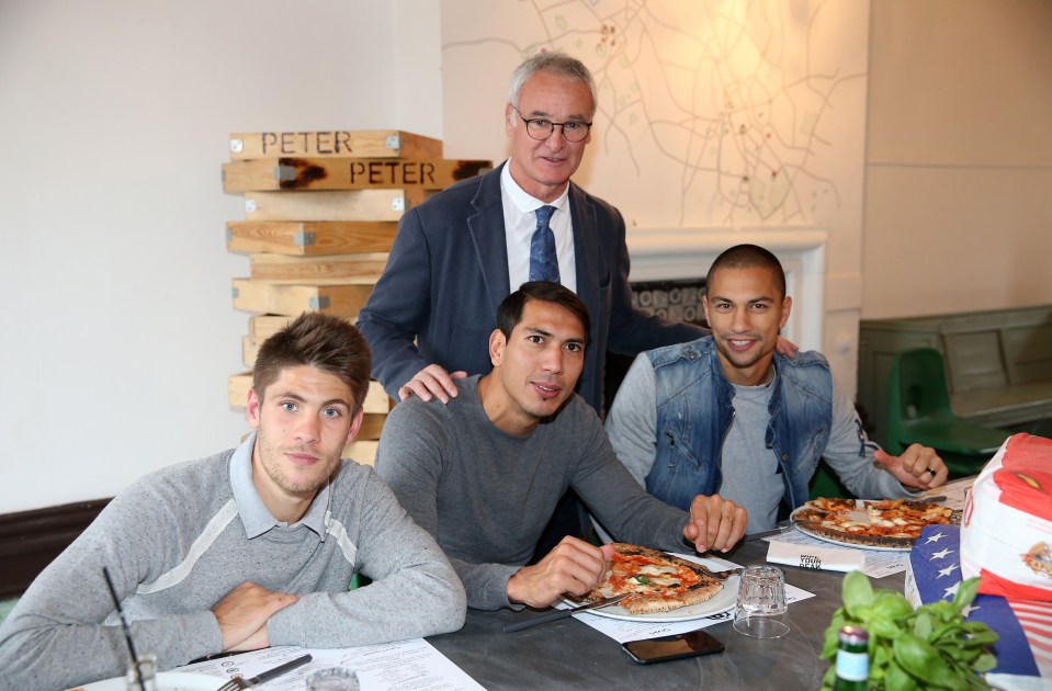 Leicester City's manager and players enjoying pizza.