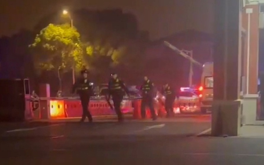 a group of police officers are walking down a street at night