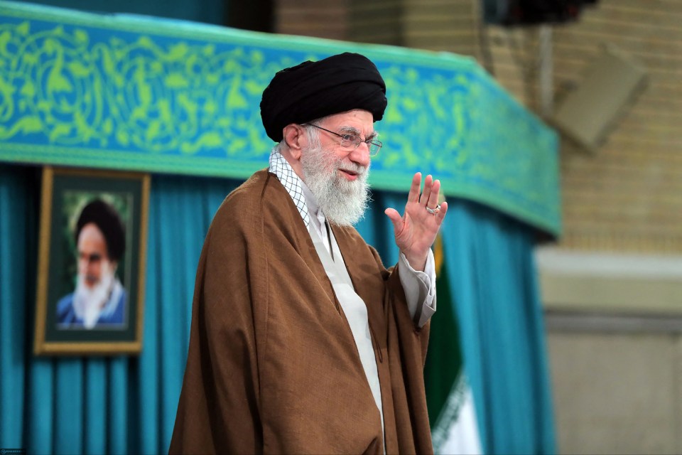 Ayatollah Ali Khamenei waving before a meeting in Tehran.