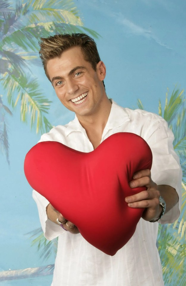 Man holding a heart-shaped pillow.