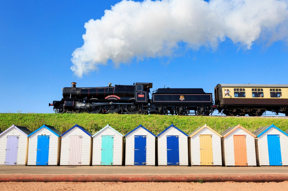 The Dartmouth Steam Railway runs past the beach huts of Goodrington Sands in Paignton