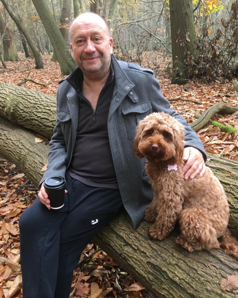 Man with dog in autumn woods.