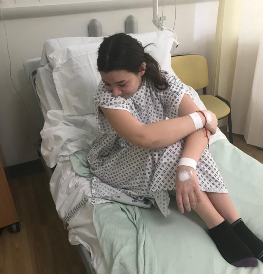 Teenage girl in hospital bed after donating bone marrow.