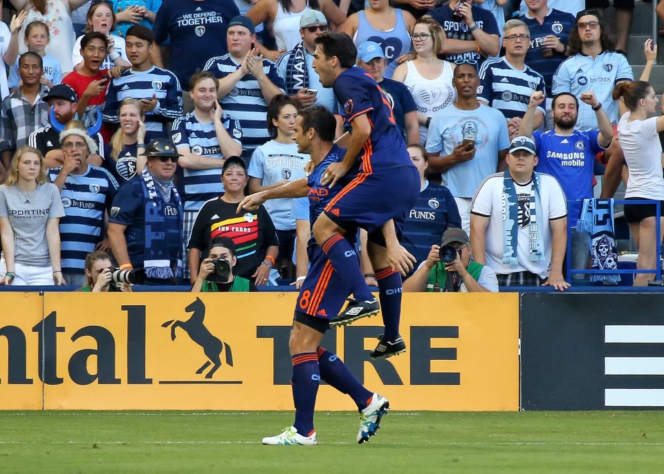 Soccer players celebrating a goal.