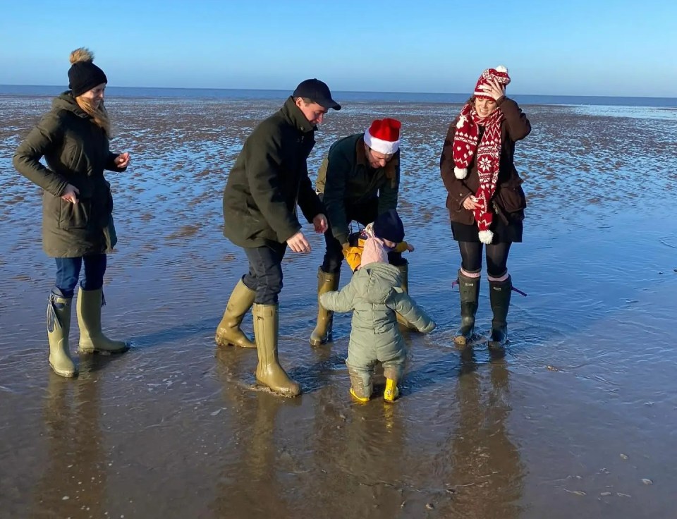 Family on a beach in winter.