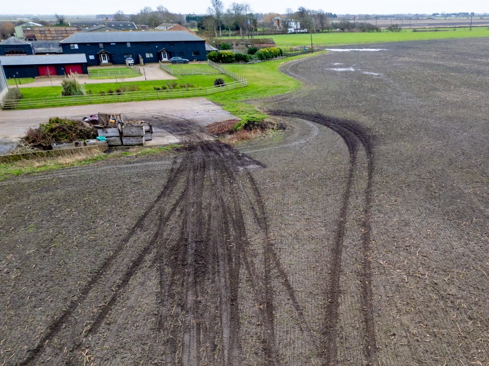 Tire tracks in a muddy field.