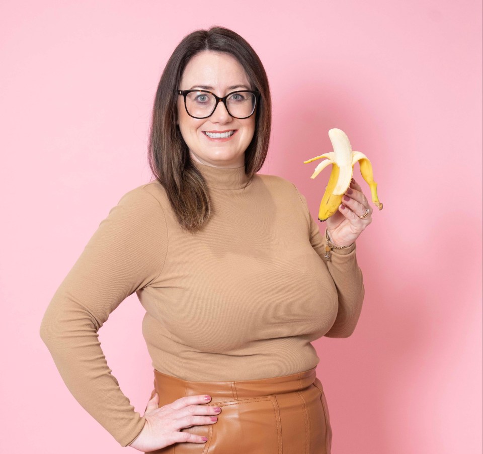 Woman holding a peeled banana.