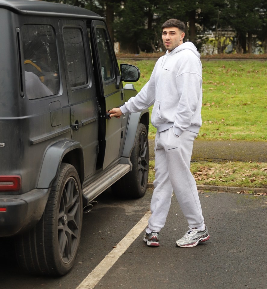 Man getting into a black SUV.