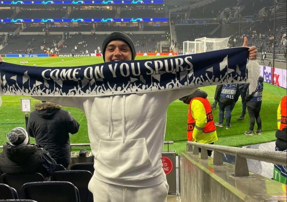 Person at a Tottenham Hotspur soccer game holding a scarf that says "Come on you Spurs".