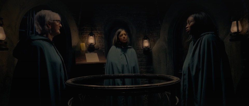 Screenshot of The Traitors, Series 3, Episode 1, showing three women in cloaks.