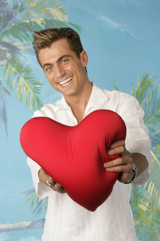 Man holding a heart-shaped pillow.