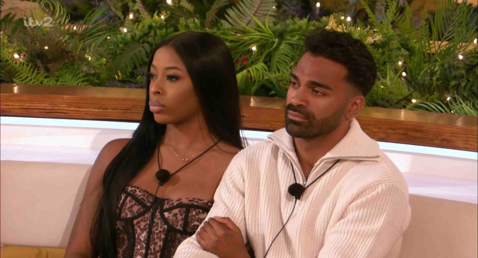 Screenshot of a man and woman from Love Island sitting together.