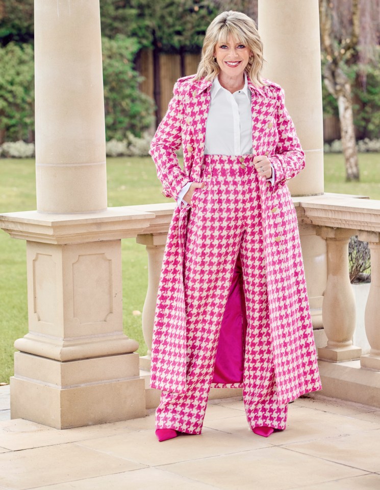 Woman in pink houndstooth suit and coat.