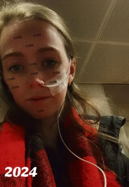 Woman with a nasal cannula and "cute" written on her face.