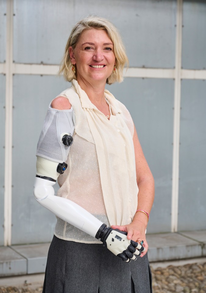 Portrait of Dr. Benjamin Marriage, a woman with a prosthetic arm, smiling.