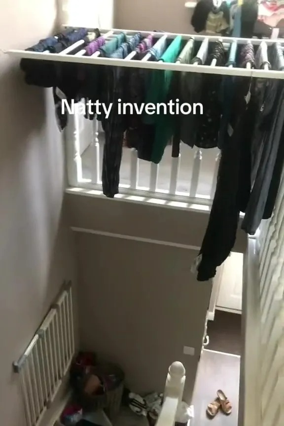 Clothes drying rack installed above a staircase.