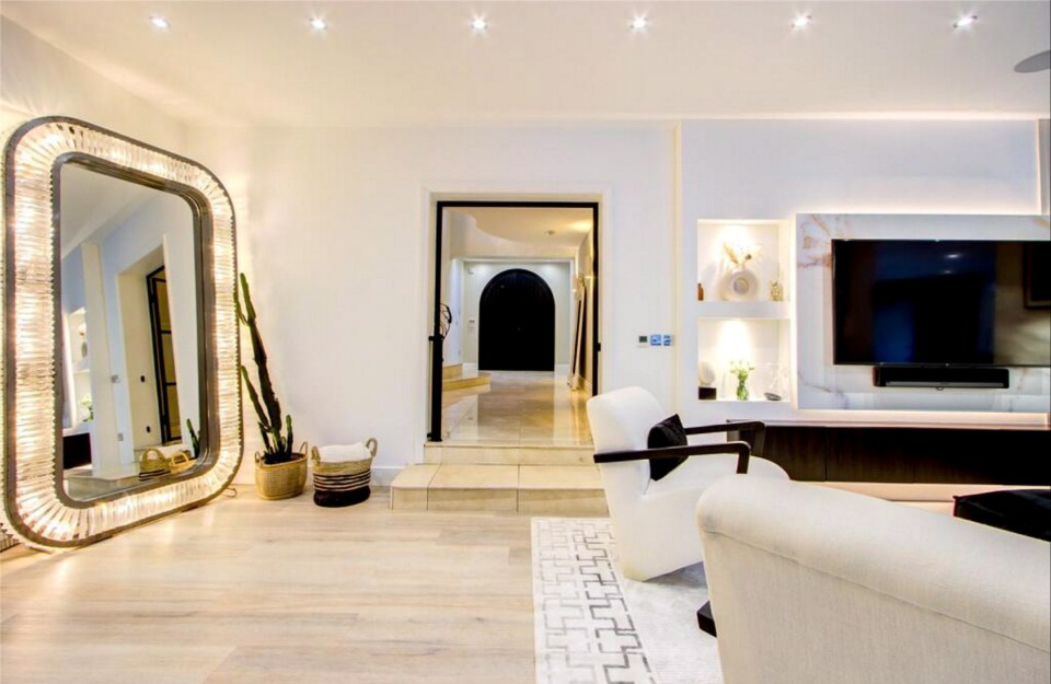 Interior of Charlotte Crosby's mansion, featuring a large mirror, living area, and hallway.