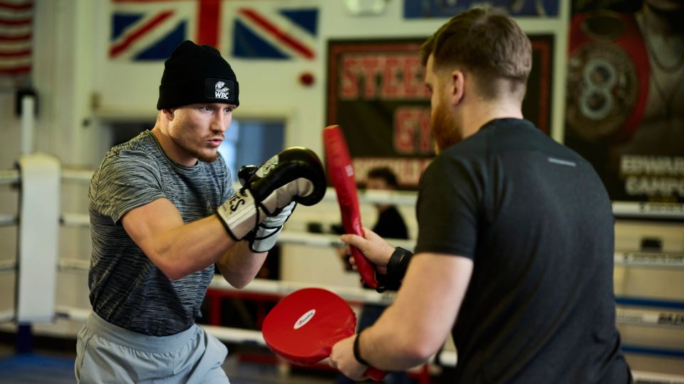 Boxer training with pads.