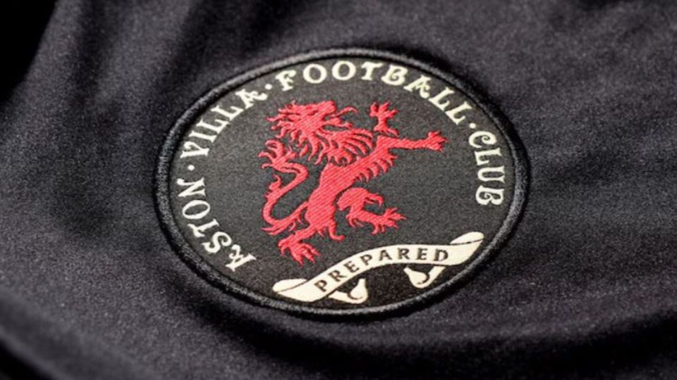 Aston Villa Football Club badge on a black shirt.