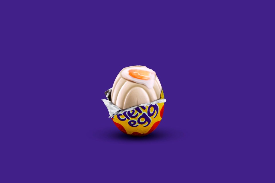 A partially unwrapped Cadbury white chocolate Creme Egg.