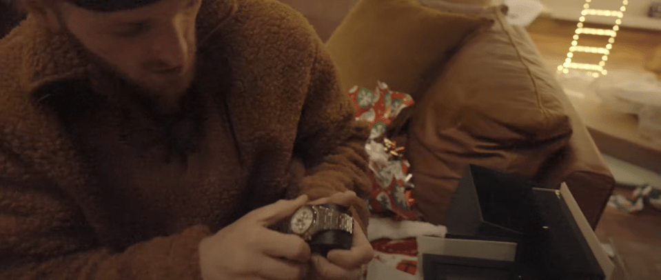 Person opening a watch gift.