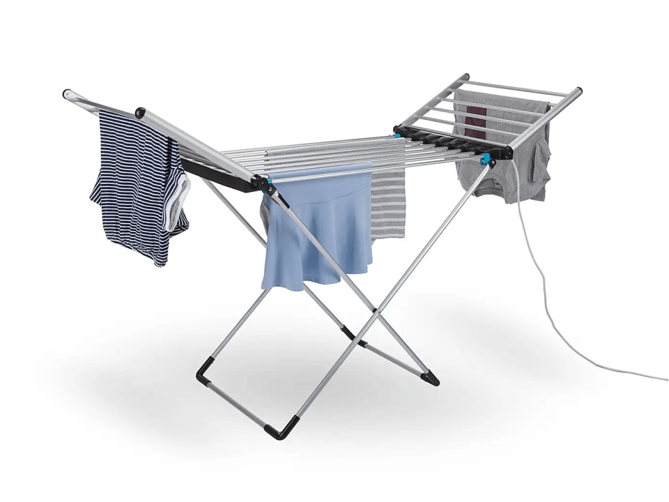 Electric clothes airer with clothes drying on it.