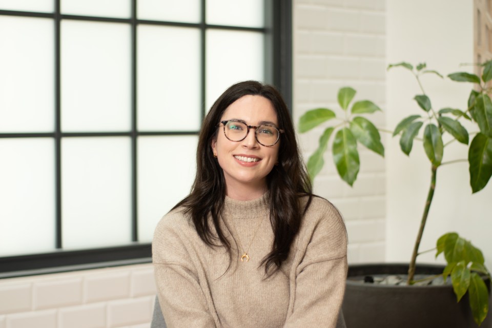 Portrait of a smiling woman wearing glasses.