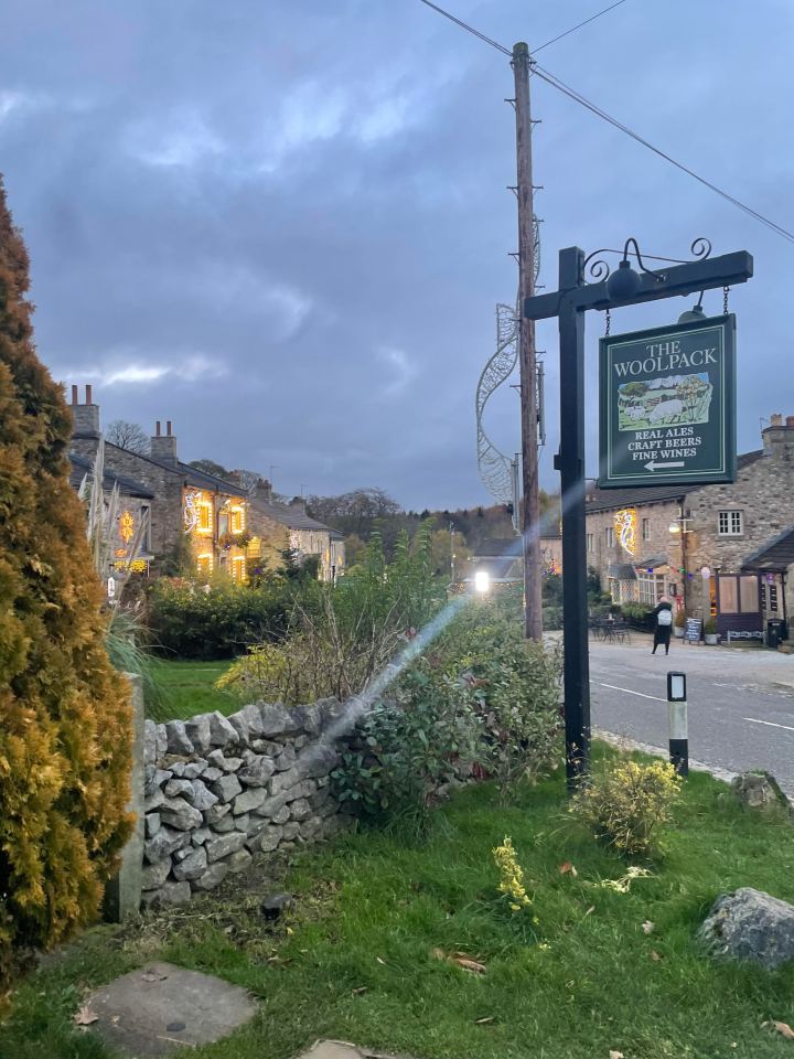 Sign for The Woolpack pub, advertising real ales, craft beers, and fine wines.