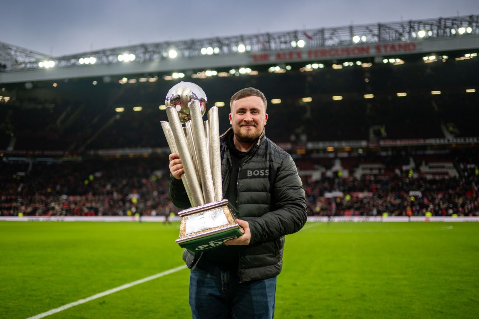 MANCHESTER, ENGLAND - JANUARY 19: Luke Littler, English darts player poses for a photo during the Premier League match between Manchester United FC and Brighton & Hove Albion FC at Old Trafford on January 19, 2025 in Manchester, England. (Photo by Ash Donelon/Manchester United via Getty Images)