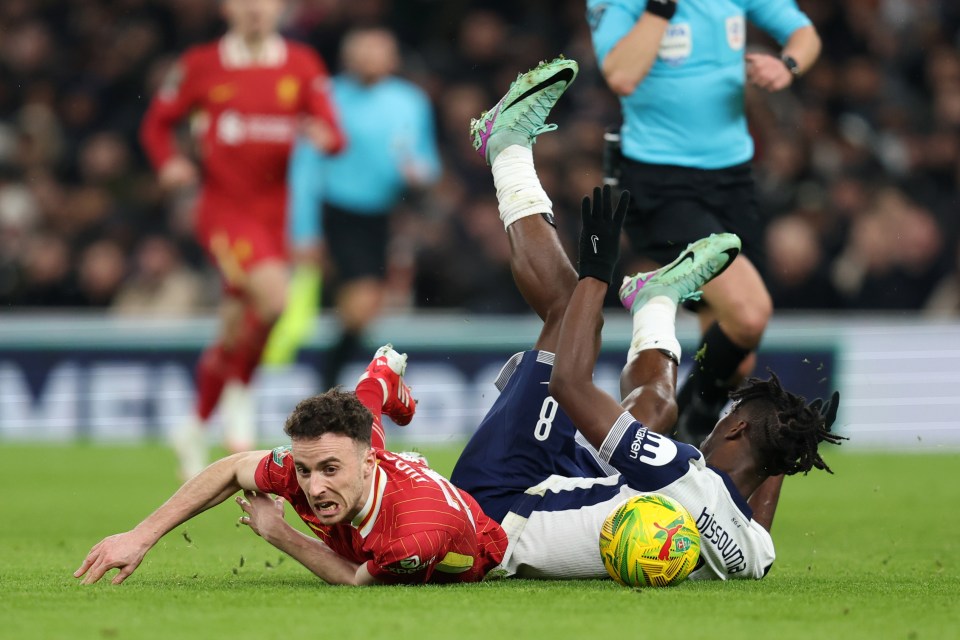 LONDON, ENGLAND - JANUARY 8: Diogo Jota of Liverpool is brought down by Yves Bissouma of Tottenham Hotspur during the Carabao Cup Semi Final First Leg match between Tottenham Hotspur and Liverpool at Tottenham Hotspur Stadium on January 8, 2025 in London, England. (Photo by Charlotte Wilson/Offside/Offside via Getty Images)