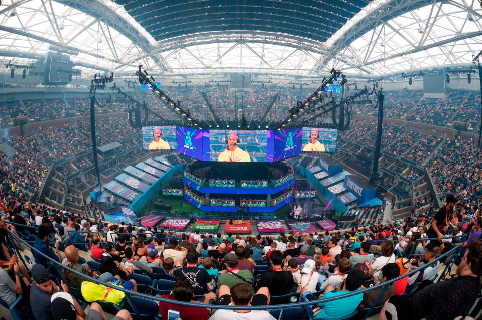 TOPSHOT - Richard Tyler Blevins (on screen), aka Ninja, speaks to the crowd at the start of the 2019 Fortnite World Cup Finals - Round Two on July 27, 2019, at Arthur Ashe Stadium, in New York City. (Photo by Johannes EISELE / AFP) (Photo by JOHANNES EISELE/AFP via Getty Images)