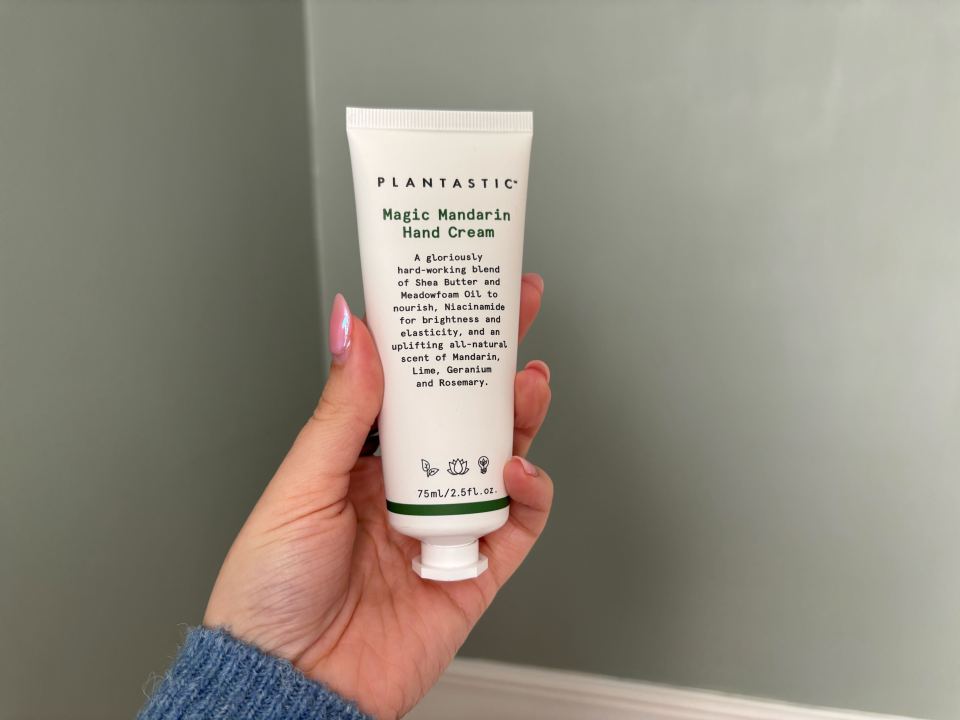 Hand cream tube in a hand.