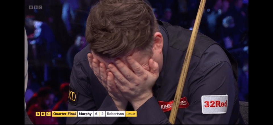 Snooker player covering his face in despair after losing a quarter-final match.