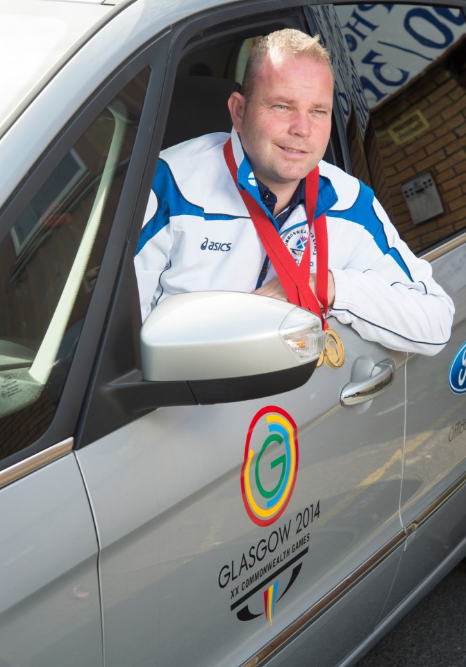 Paul Foster, a double gold medalist in bowls at the 2014 Glasgow Commonwealth Games, sits in his taxi.