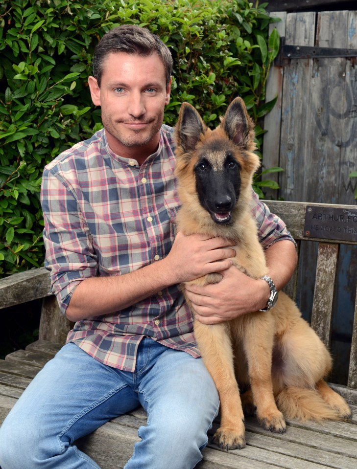 Dean Gaffney holding a puppy.