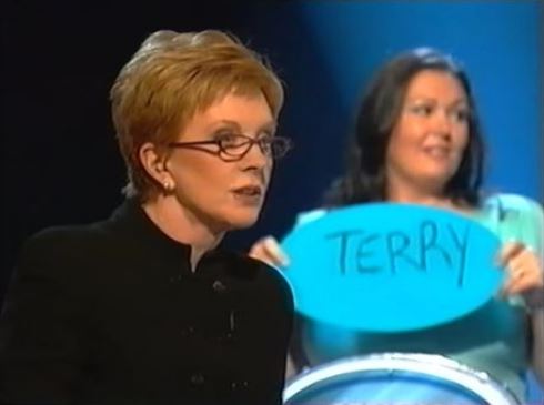 Anne Robinson on the Weakest Link, with a contestant holding a sign that says "Terry".