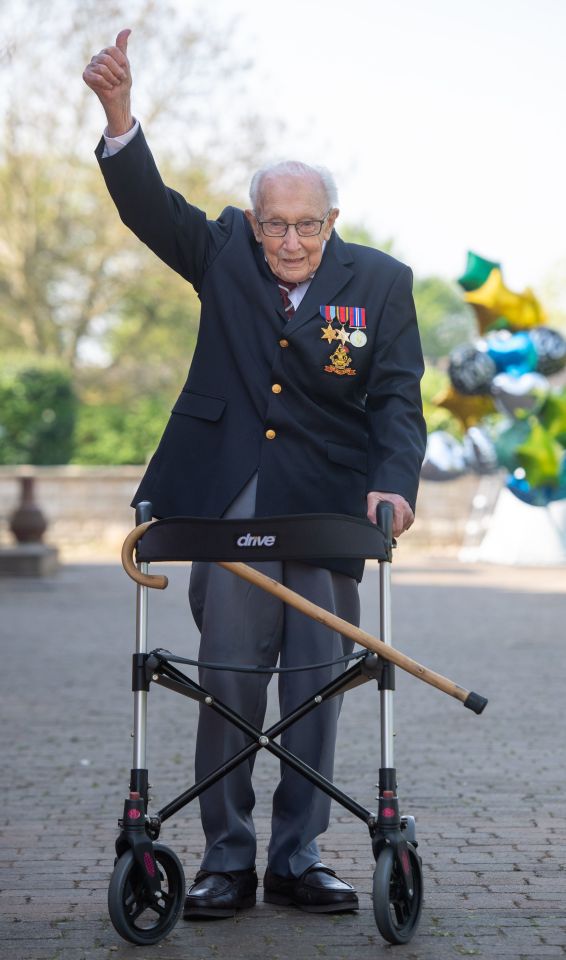 Captain Tom Moore giving a thumbs up while using a walking frame.