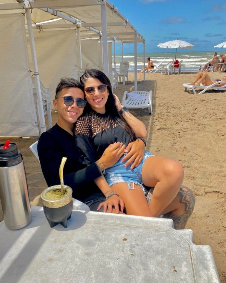 Couple embracing on a beach.