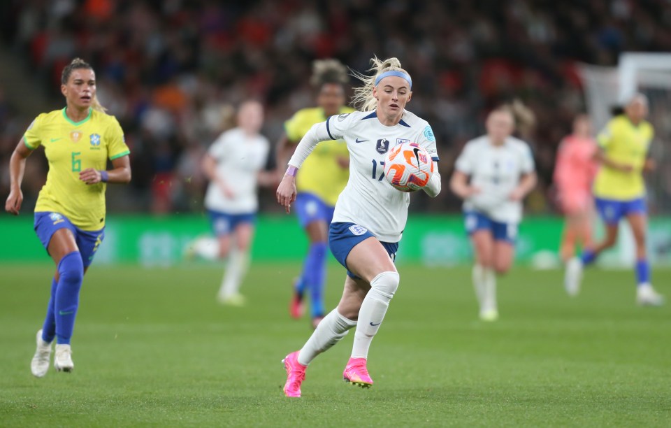 Chloe Kelly of England dribbling the soccer ball during a match.