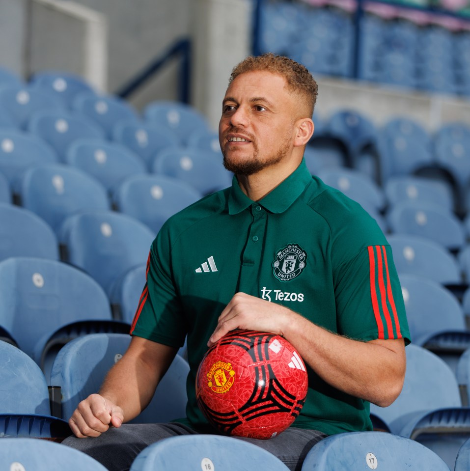 Wes Brown at a Manchester United photocall, holding a soccer ball.