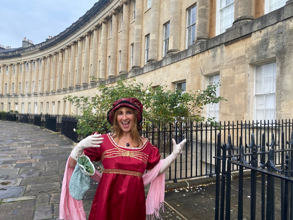 Woman in period costume in front of the Royal Crescent in Bath.