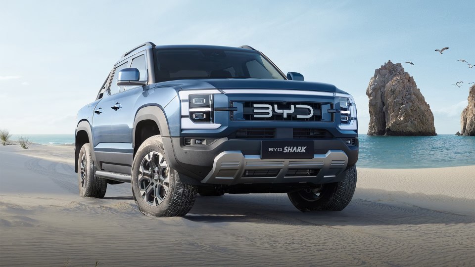 BYD Shark pickup truck on a sandy beach.