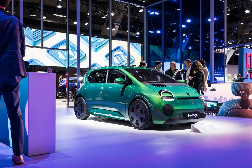 Green electric concept car on display at a car show.