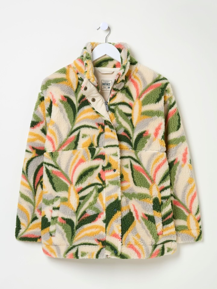 Floral patterned fleece jacket on a hanger.