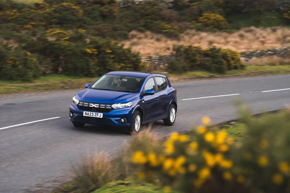 Blue car driving on a road.