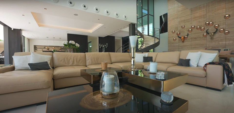 Modern living room with beige sectional sofa and coffee tables.